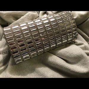 Never used- stunning mirrored clutch.